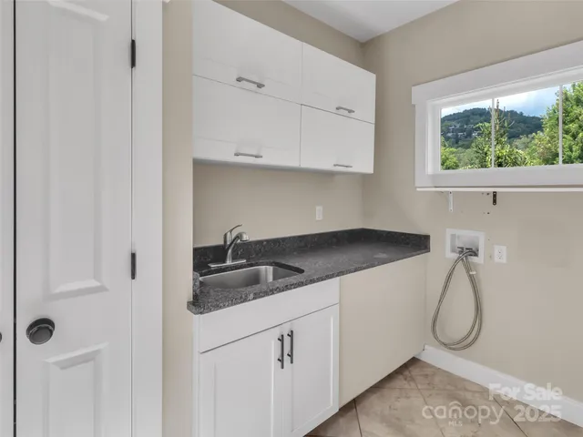 a kitchen with a sink and cabinets