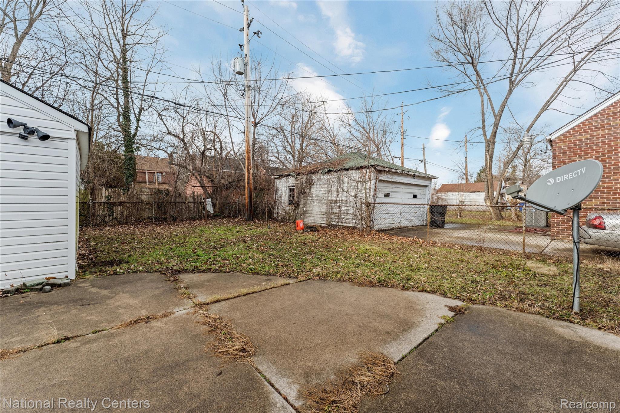 5525 Cadieux Road Detroit, MI 48224 - Photo 16 of 19 View of yard featuring an outdoor structure and a detached garage