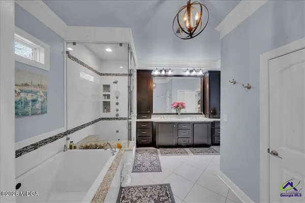 a bathroom with a granite countertop sink a mirror and a bathtub