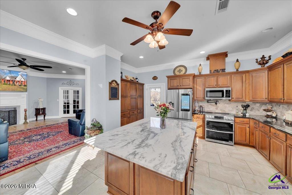 706 Orr Road Fort Valley, GA 31030 - Photo 8 of 50 a kitchen with stainless steel appliances granite countertop a stove oven and a sink