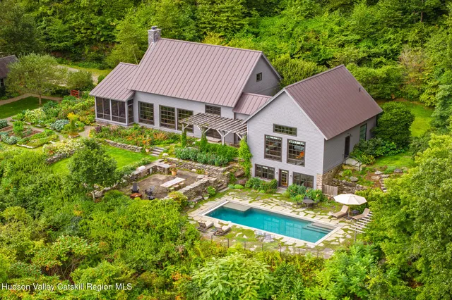 a aerial view of a house with swimming pool and garden