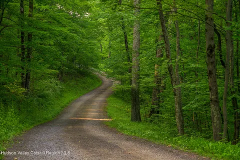 a living room with furniture and a large window with wooden floor