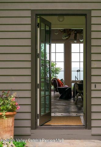 a white bath tub sitting in a en suite bathroom next to a window