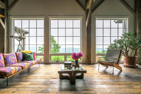 a living room with furniture a table and chairs