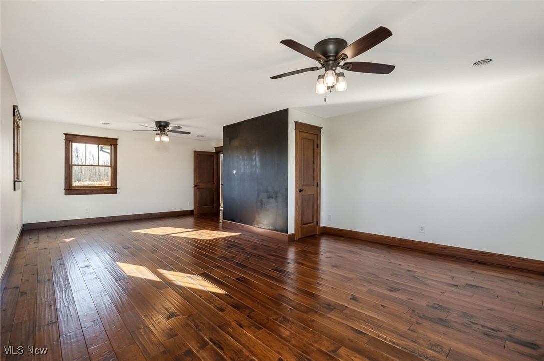 9615 Rural Dale Road Blue Rock, OH 43720 - Photo 31 of 50 Empty room with dark wood-style flooring and a ceiling fan