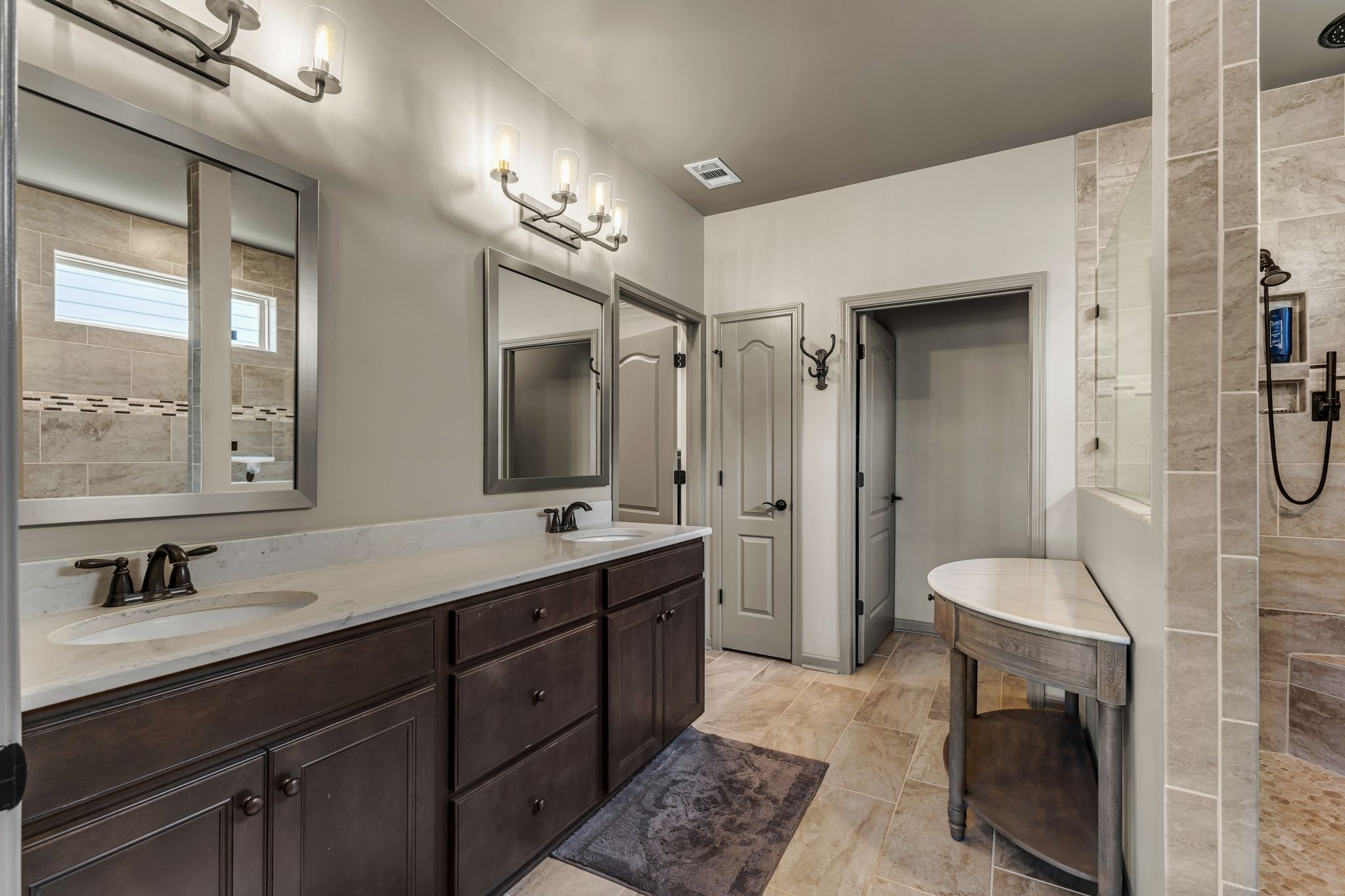 1121 Davidson Walk Spring Hill, TN 37174 - Photo 17 of 27 a spacious bathroom with a double vanity sink a large mirror and a shower