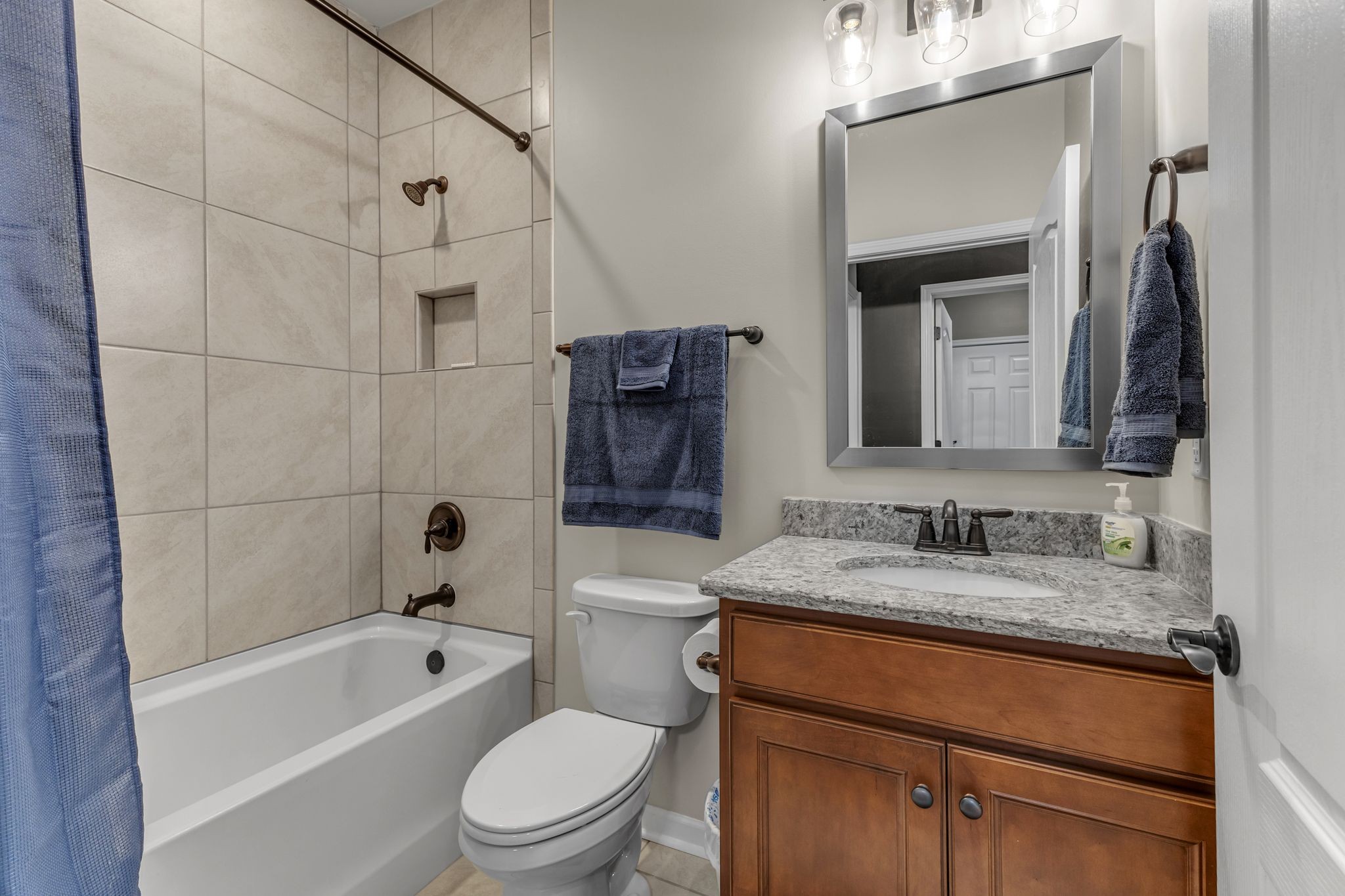 1121 Davidson Walk Spring Hill, TN 37174 - Photo 25 of 27 a bathroom with a granite countertop sink toilet and shower