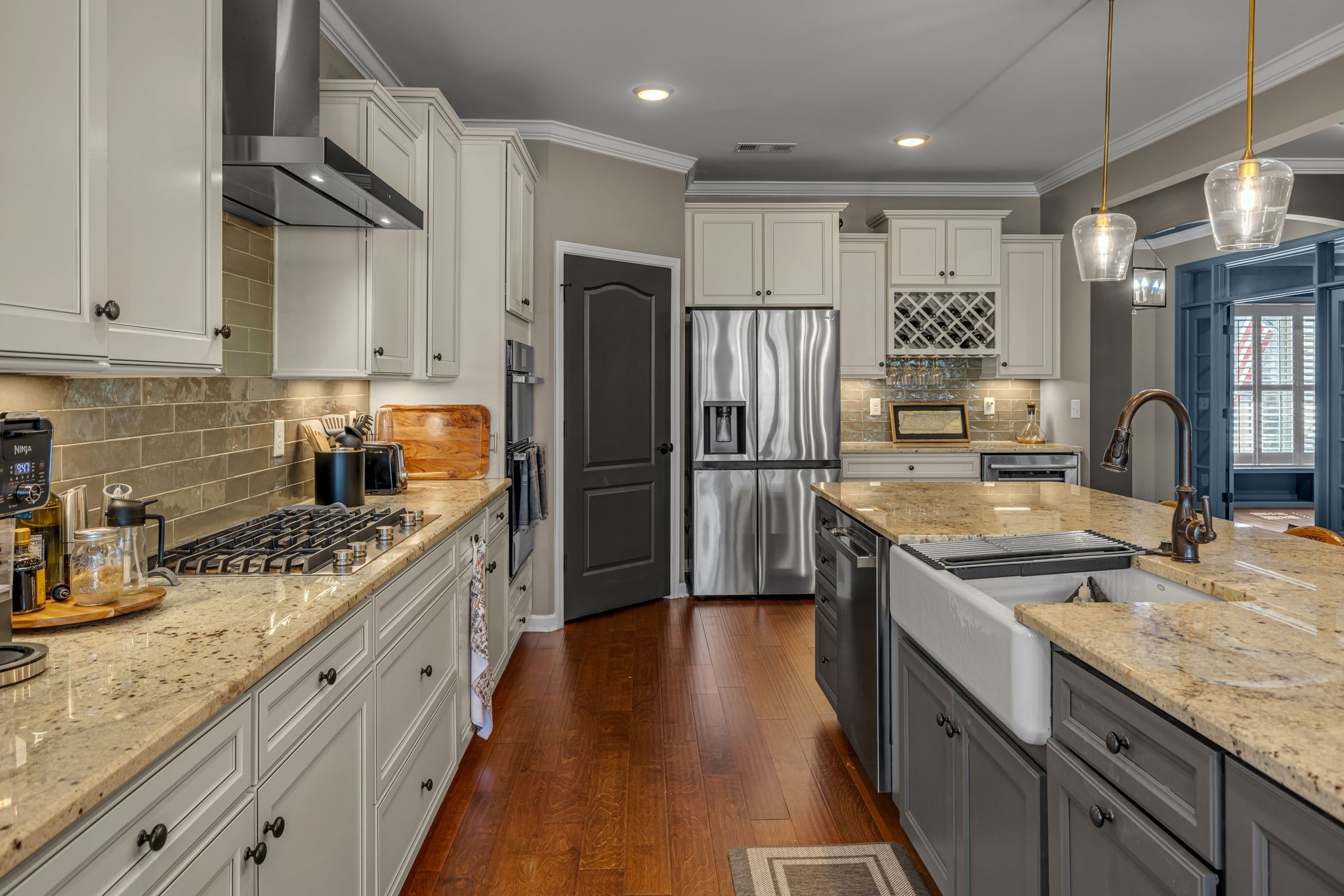 1121 Davidson Walk Spring Hill, TN 37174 - Photo 8 of 27 a kitchen with stainless steel appliances granite countertop a refrigerator a sink dishwasher a stove and white cabinets with wooden floor