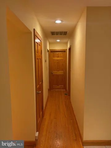 a view of hallway with wooden floor