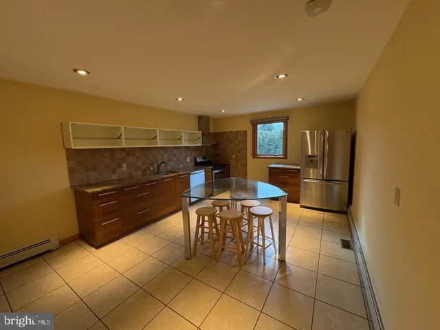 a bathroom with a tub a sink and shower