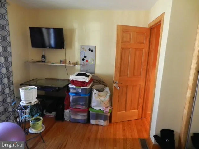 a room with wooden floor and utility room