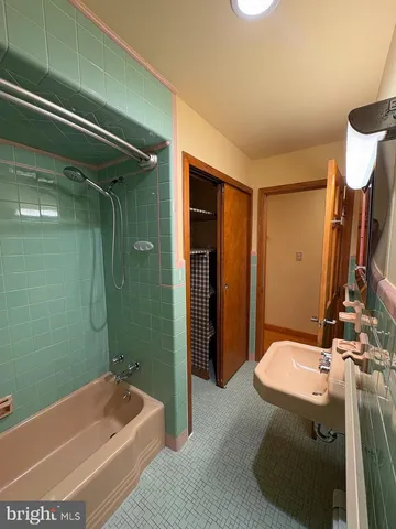 a bathroom with sink toilet and shower