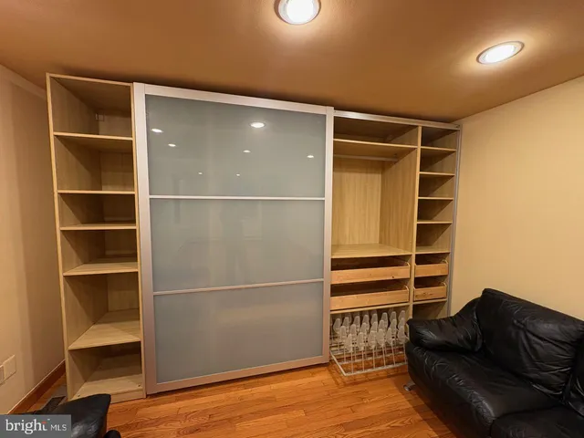 a view of walk in closet with empty racks