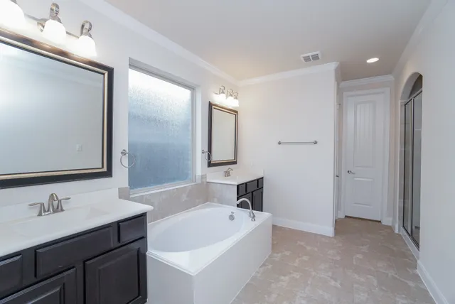 a bathroom with a bathtub and a sink
