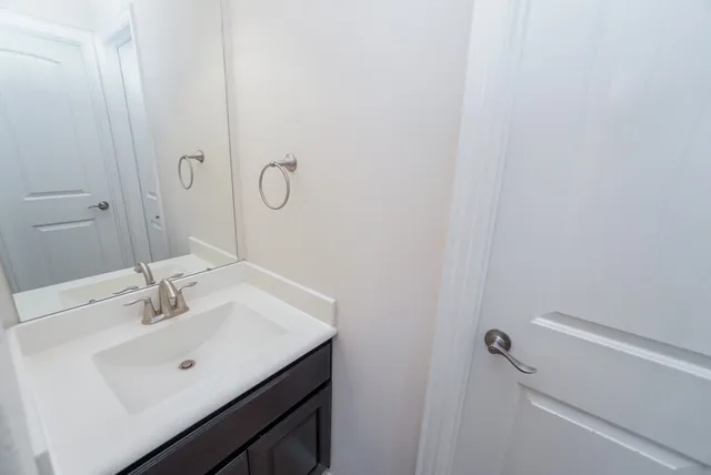 a bathroom with a sink a mirror and vanity
