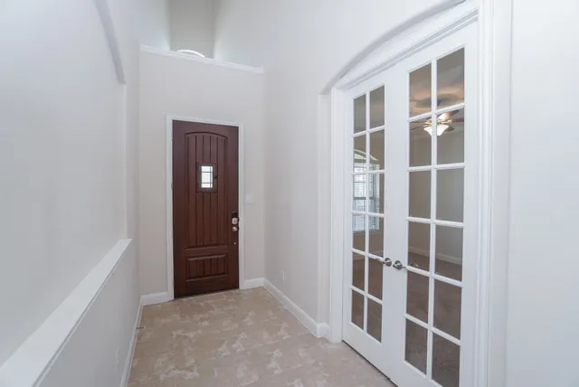 an empty room with windows and closet