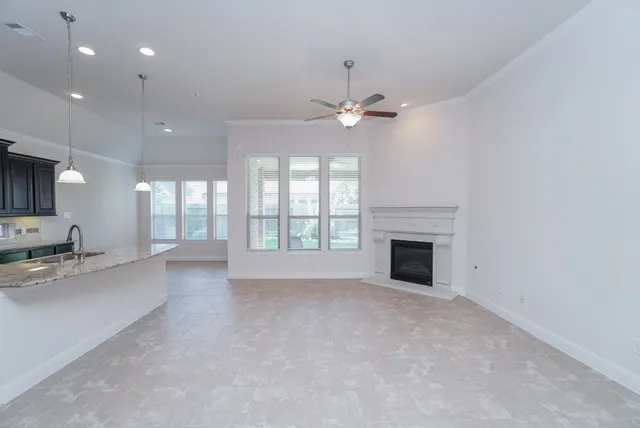 a view of an empty room with a fireplace and a window