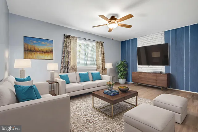 a living room with furniture a window and a flat screen tv