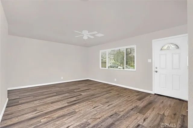 wooden floor in an empty room with a window
