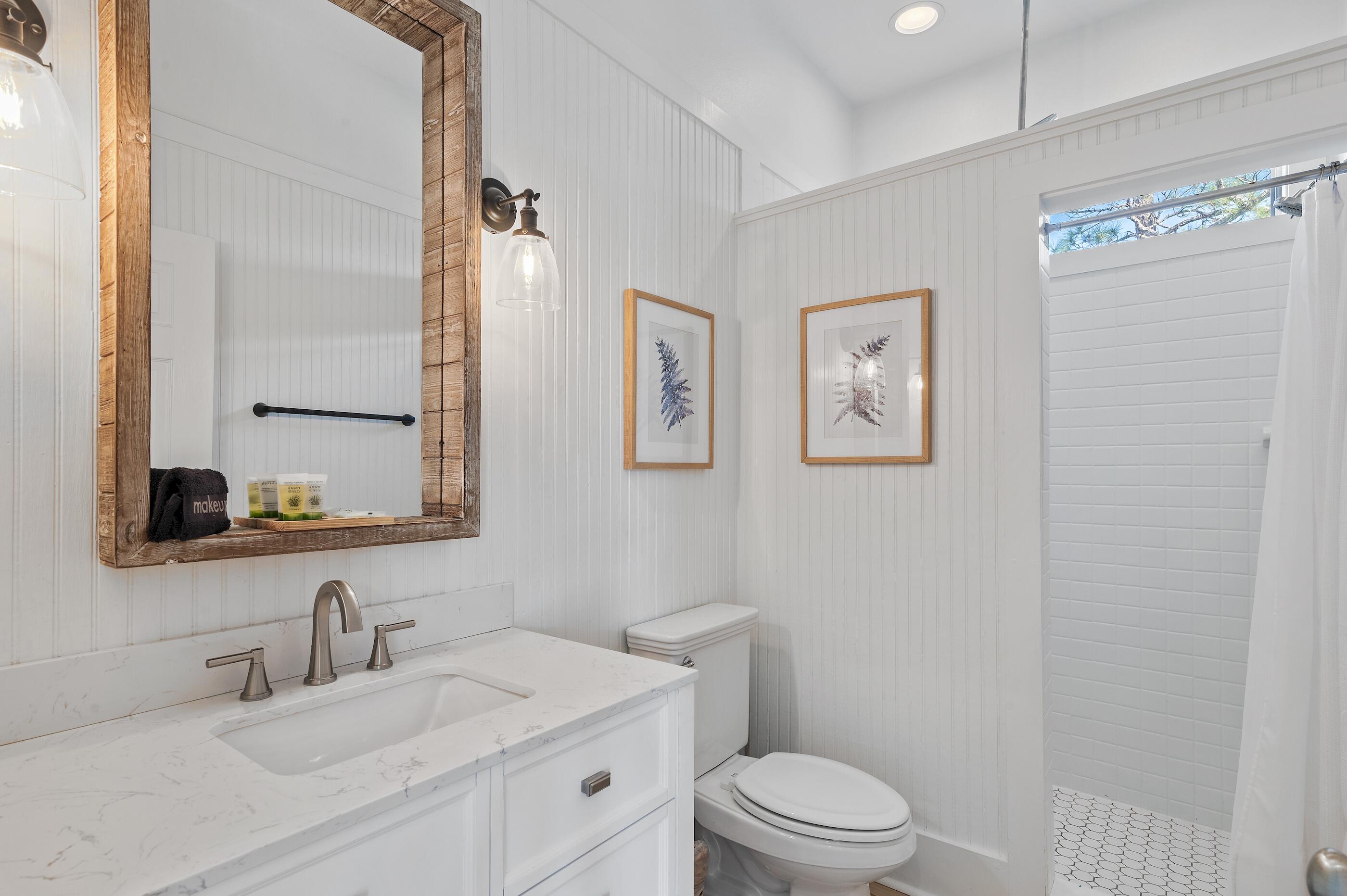348 Lakewood Drive Santa Rosa Beach, FL 32459 - Photo 13 of 46 a bathroom with a sink a toilet and a mirror