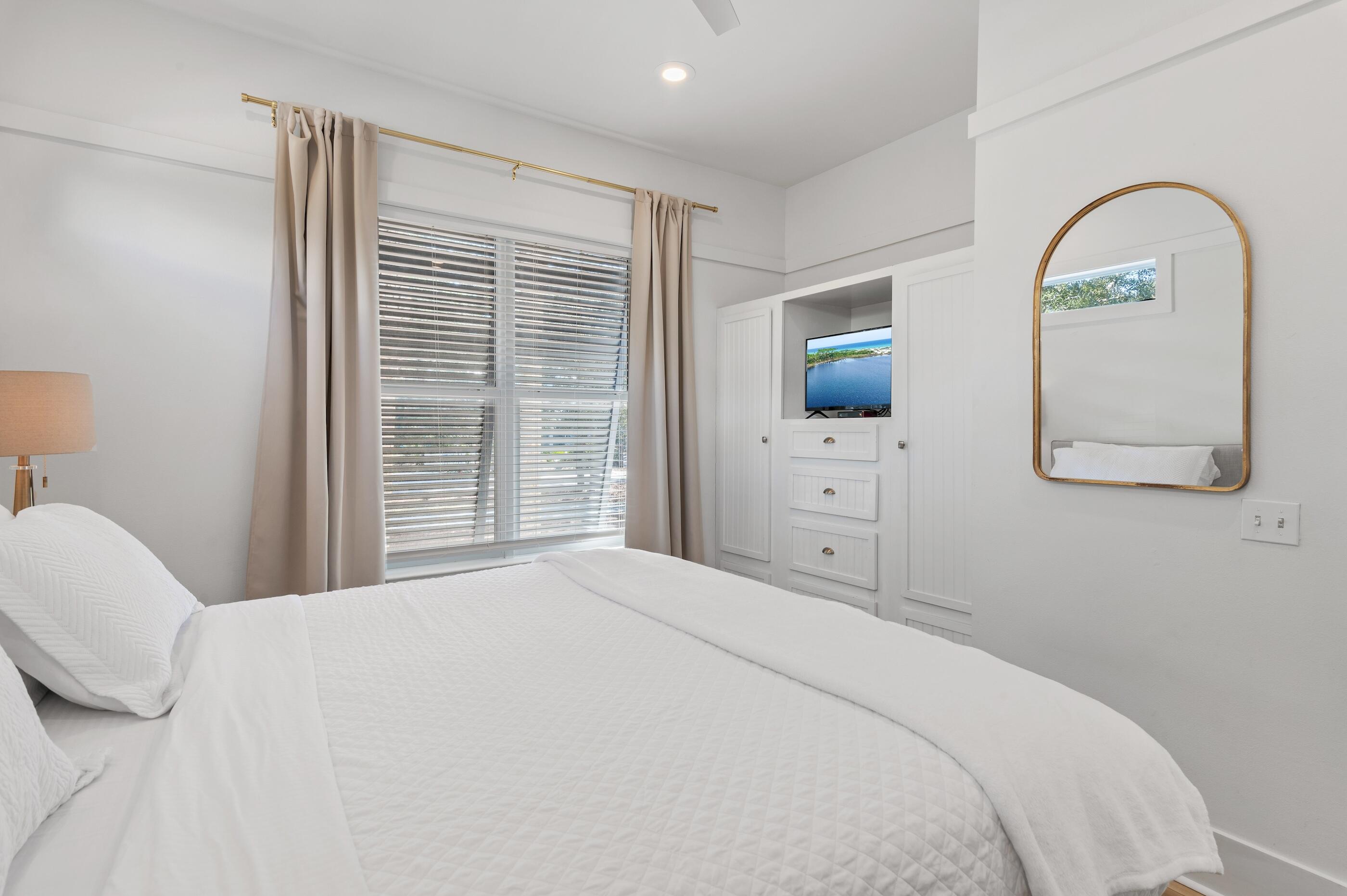 348 Lakewood Drive Santa Rosa Beach, FL 32459 - Photo 15 of 46 a bedroom with a bed and a flat screen tv