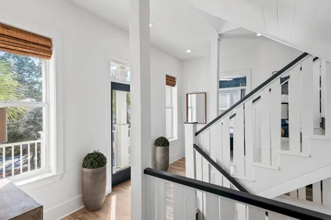 a view of an entryway with wooden floor and windows