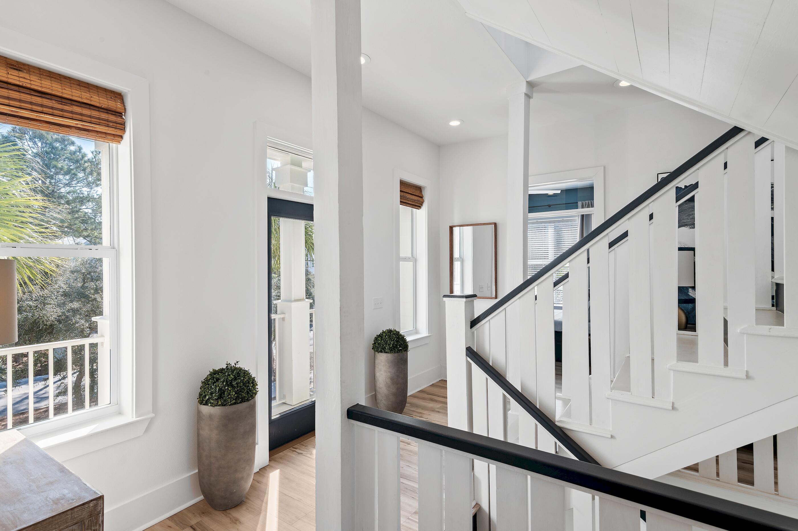 348 Lakewood Drive Santa Rosa Beach, FL 32459 - Photo 20 of 46 a view of an entryway with wooden floor and windows