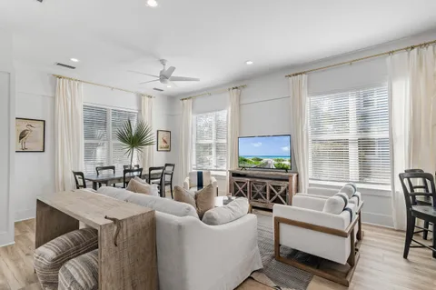 a living room with furniture a large window and a flat screen tv