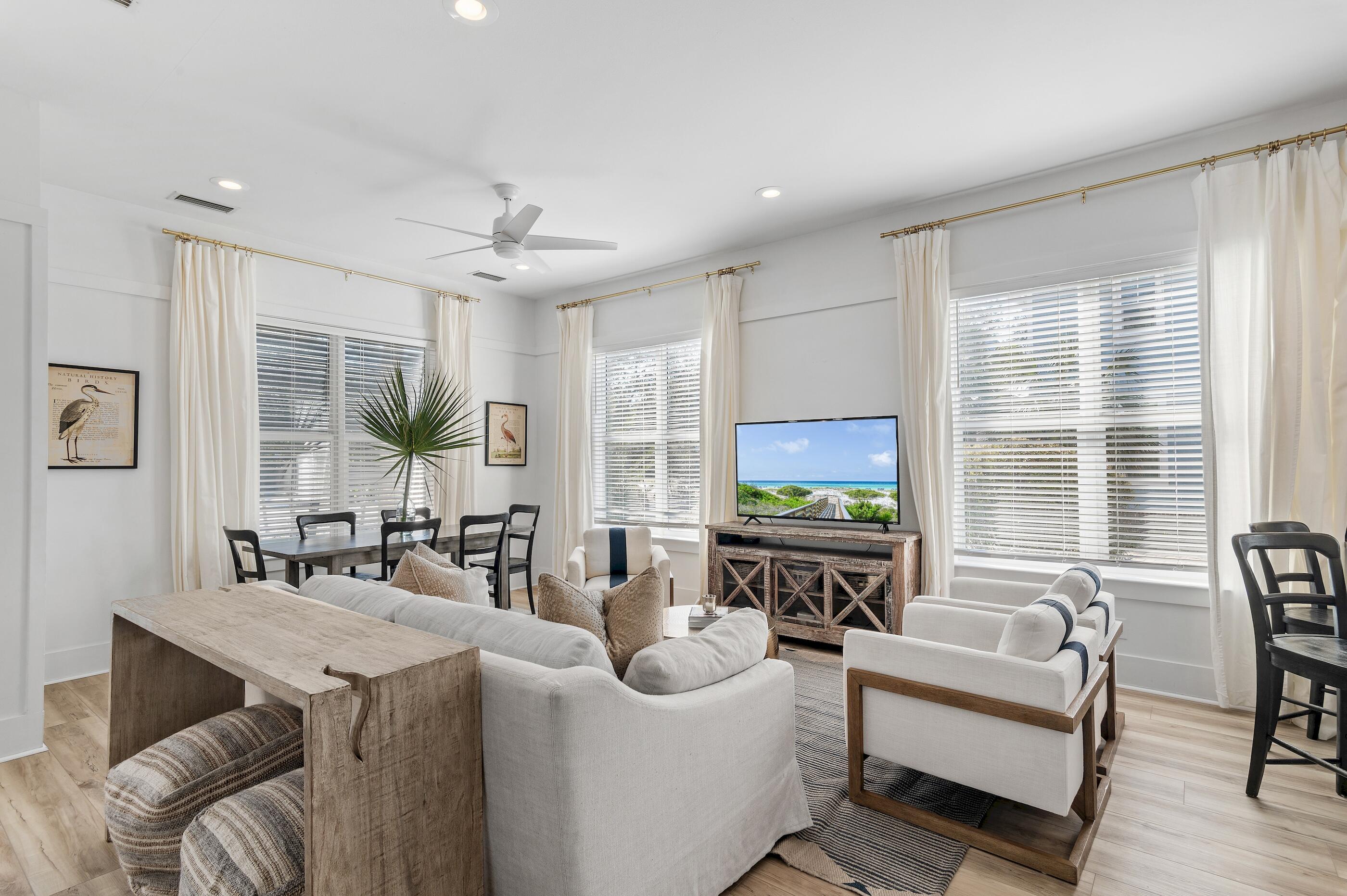 348 Lakewood Drive Santa Rosa Beach, FL 32459 - Photo 3 of 46 a living room with furniture a large window and a flat screen tv