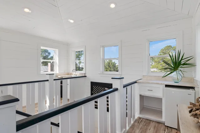 a view of entryway and hall with wooden floor