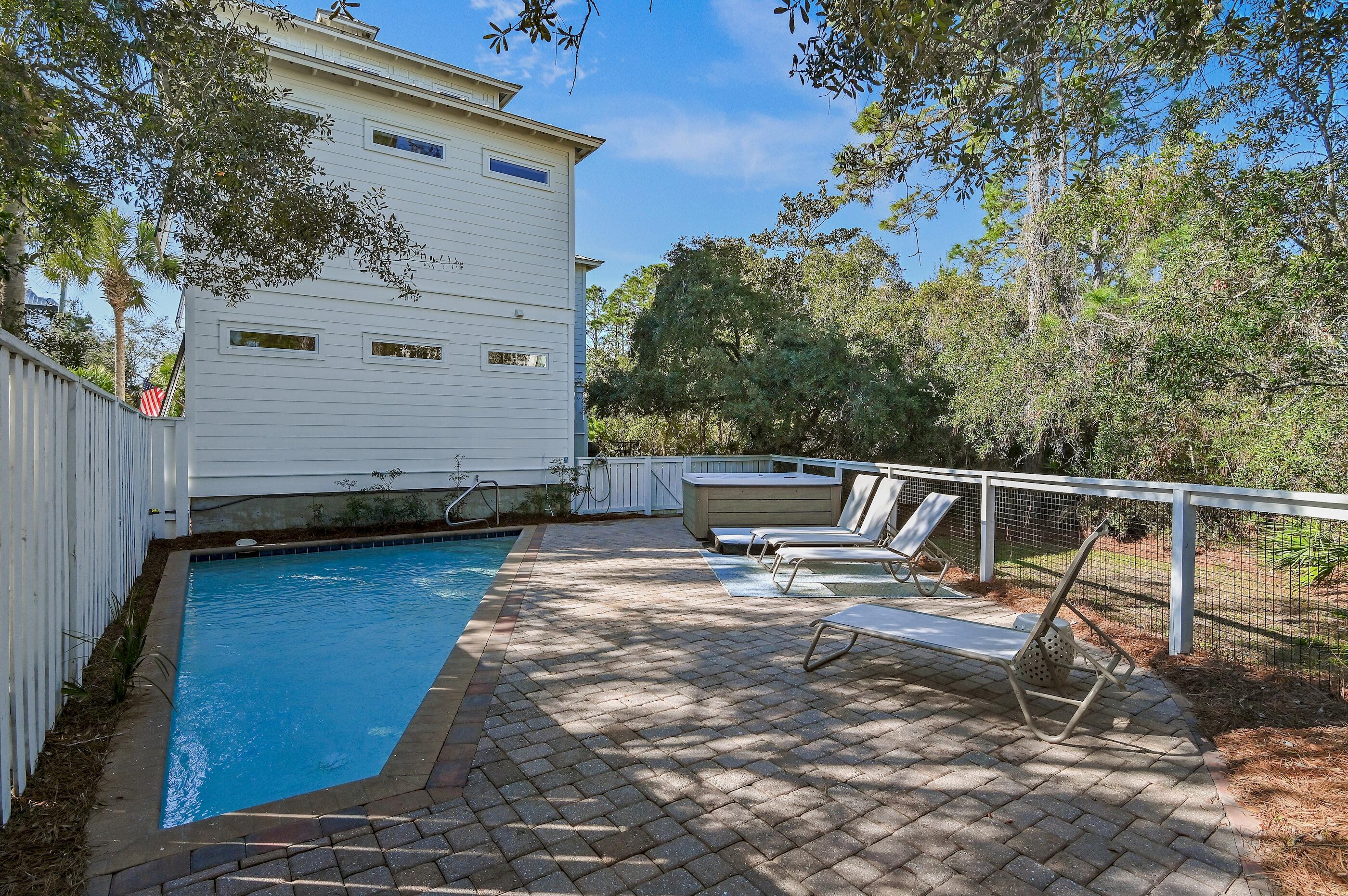 348 Lakewood Drive Santa Rosa Beach, FL 32459 - Photo 43 of 46 a view of a chair and tables on the deck