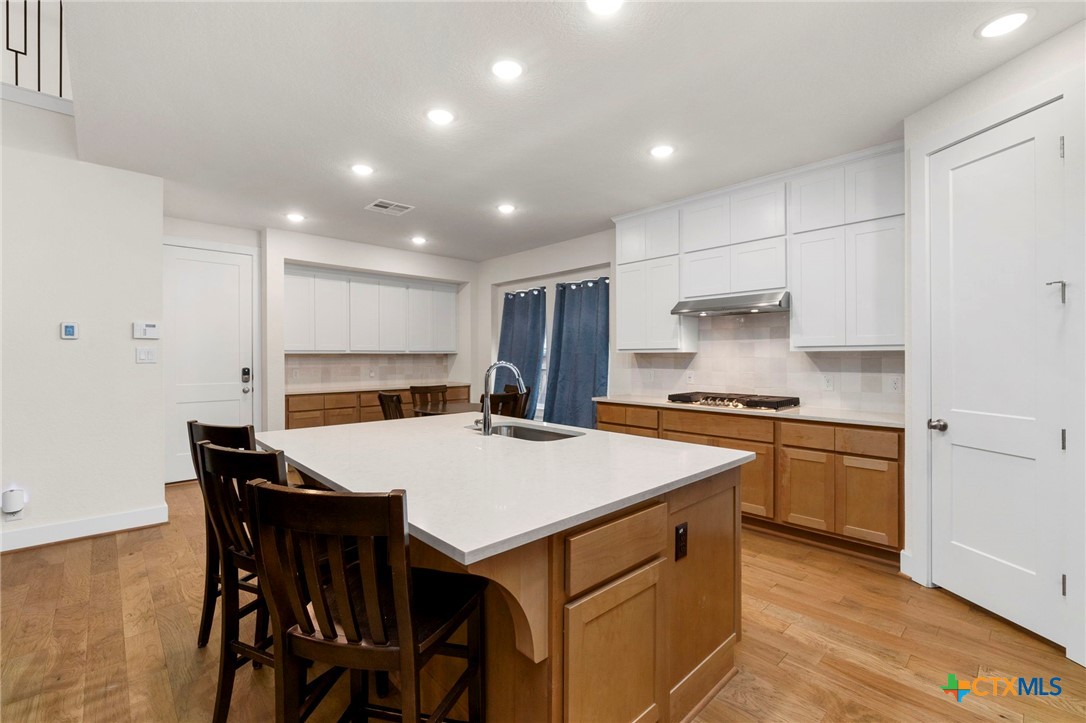 1845 Nettletree Road New Braunfels, TX 78132 - Photo 11 of 33 a kitchen with a stove a table and chairs