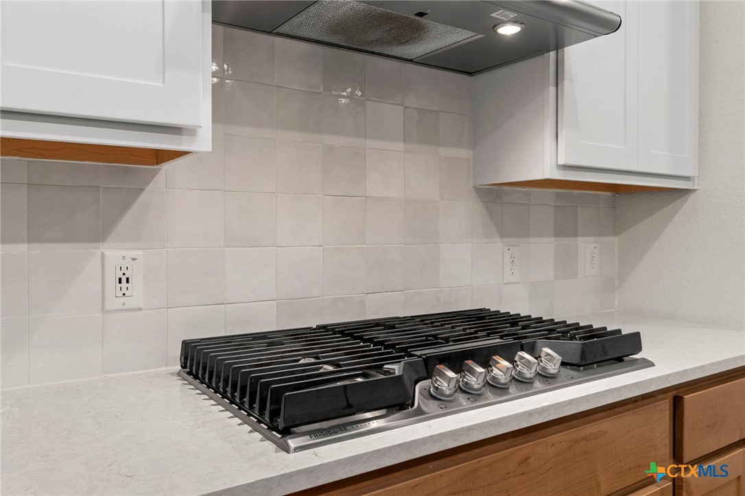 1845 Nettletree Road New Braunfels, TX 78132 - Photo 14 of 33 a close up of a stove top oven sitting inside of a kitchen