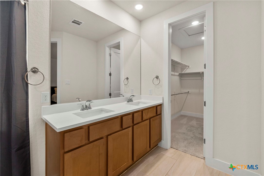 1845 Nettletree Road New Braunfels, TX 78132 - Photo 20 of 33 a bathroom with a sink and a mirror