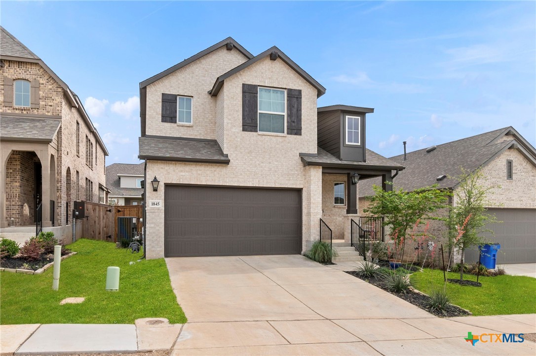 1845 Nettletree Road New Braunfels, TX 78132 - Photo 2 of 33 a front view of a house with a yard and garage
