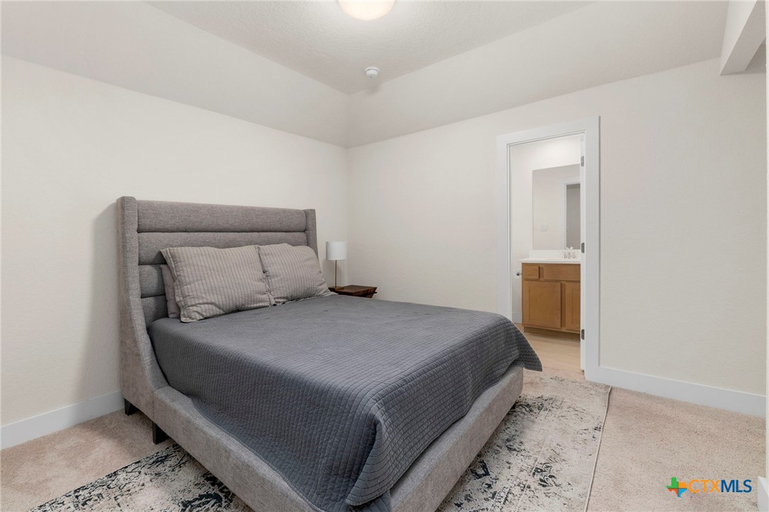 1845 Nettletree Road New Braunfels, TX 78132 - Photo 24 of 33 a bedroom with a bed and cabinet