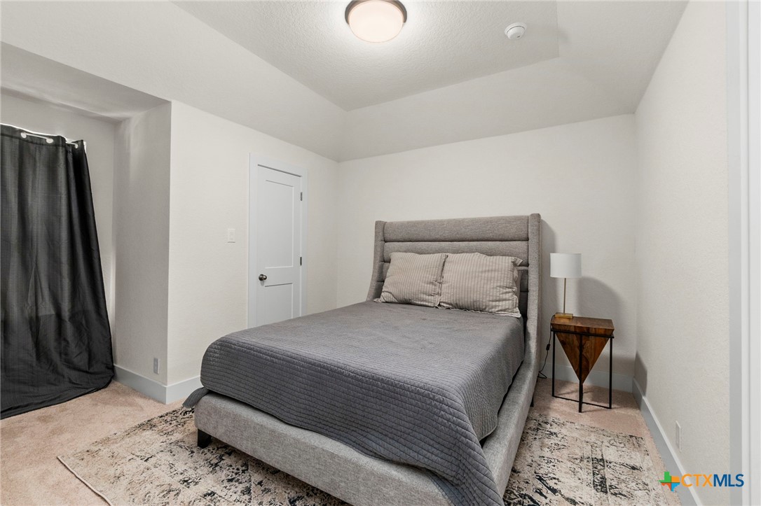 1845 Nettletree Road New Braunfels, TX 78132 - Photo 25 of 33 a bedroom with a bed and a mirror