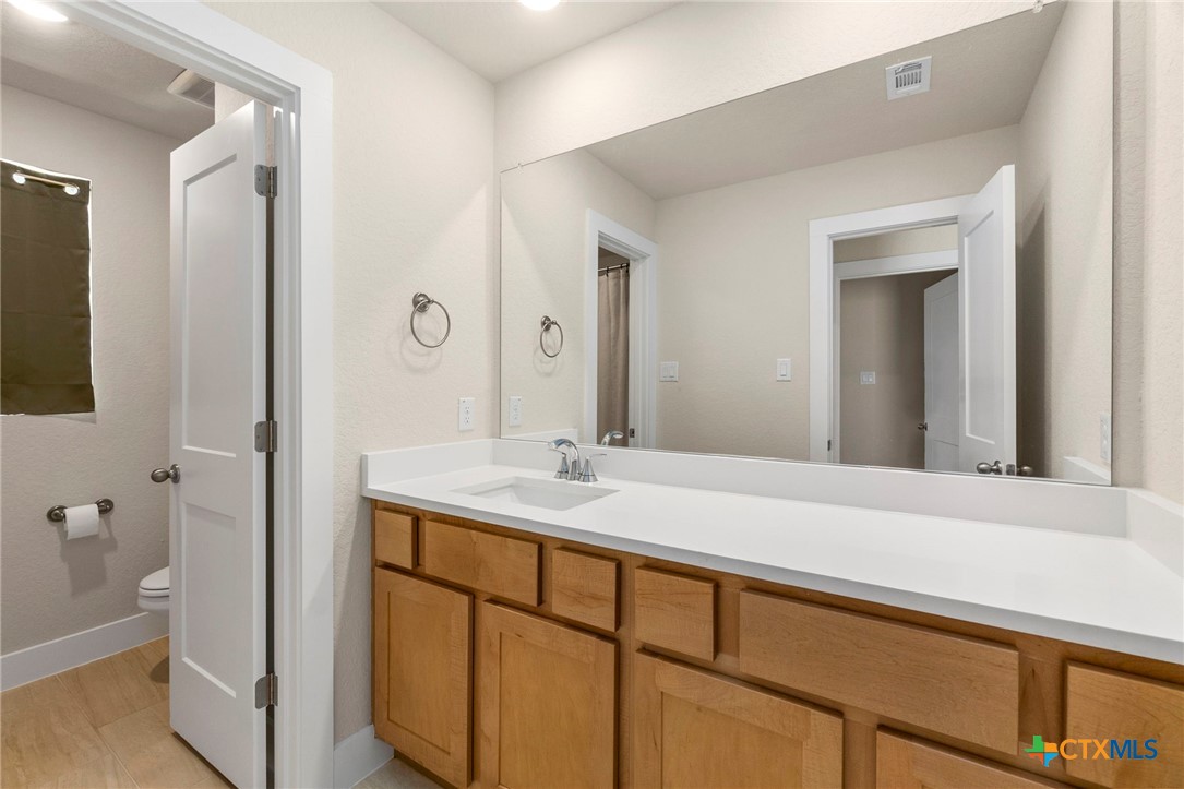 1845 Nettletree Road New Braunfels, TX 78132 - Photo 26 of 33 a bathroom with a sink and a mirror