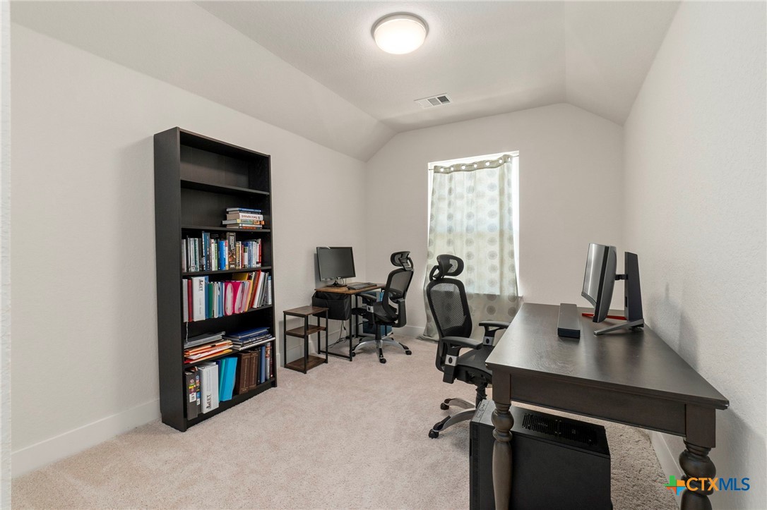 1845 Nettletree Road New Braunfels, TX 78132 - Photo 28 of 33 a view of a workspace with furniture and a bookshelf