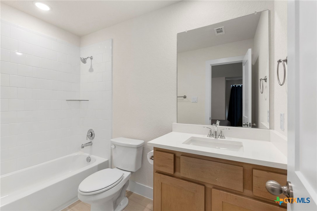 1845 Nettletree Road New Braunfels, TX 78132 - Photo 29 of 33 a bathroom with a sink toilet vanity and shower