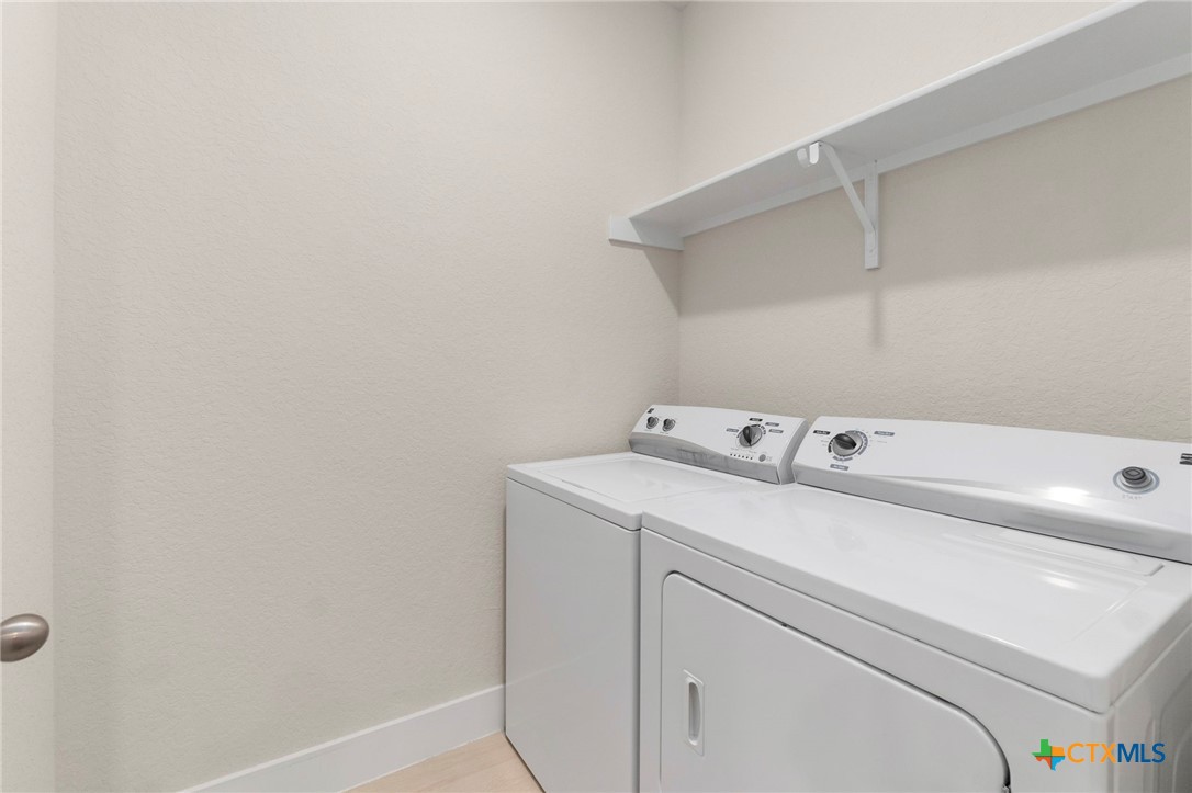 1845 Nettletree Road New Braunfels, TX 78132 - Photo 30 of 33 a utility room with dryer and washer