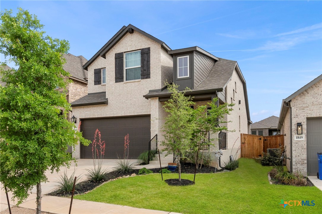 1845 Nettletree Road New Braunfels, TX 78132 - Photo 3 of 33 a front view of a house with a yard and garage