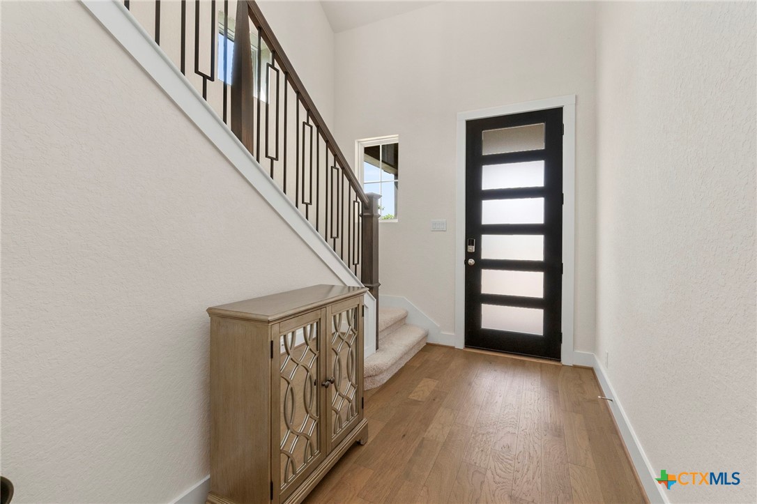 1845 Nettletree Road New Braunfels, TX 78132 - Photo 4 of 33 a view of staircase with wooden floor and white walls