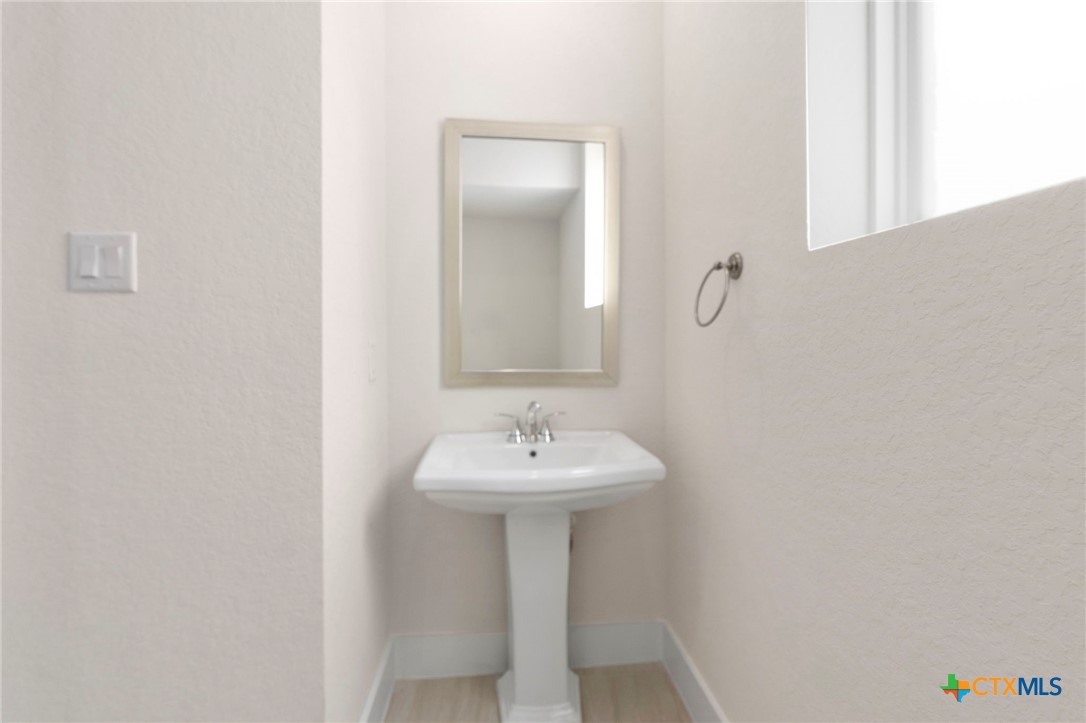 1845 Nettletree Road New Braunfels, TX 78132 - Photo 5 of 33 a bathroom with a sink and a mirror