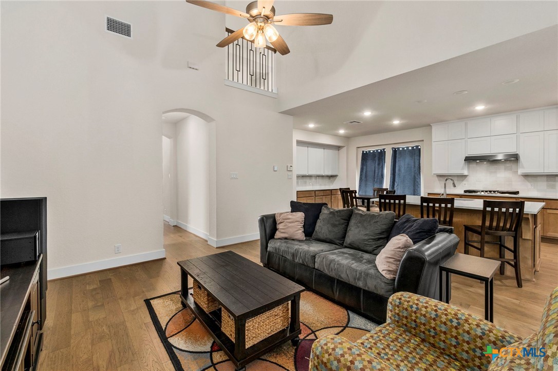 1845 Nettletree Road New Braunfels, TX 78132 - Photo 8 of 33 a living room with furniture and a chandelier
