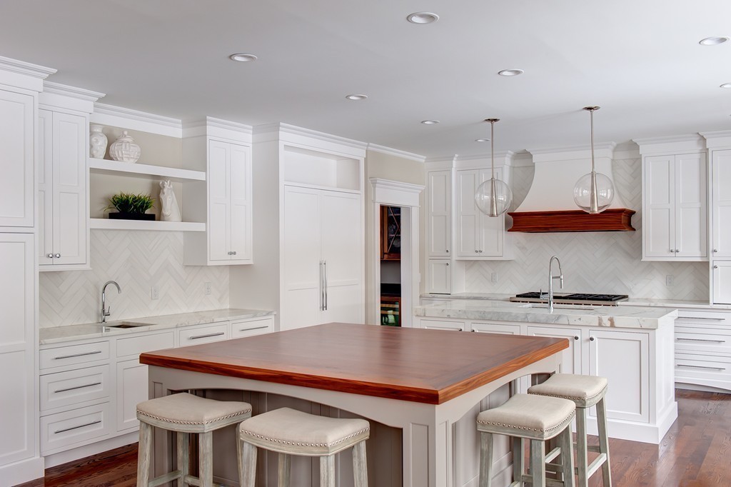 65 White Oak Road Wellesley, MA 02481 - Photo 8 of 28 a kitchen with stainless steel appliances granite countertop a kitchen island a stove a sink dishwasher and white cabinets with wooden floor