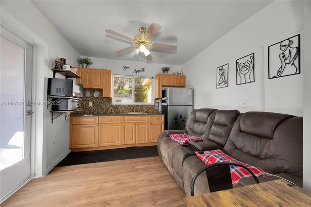 a living room with furniture and kitchen view