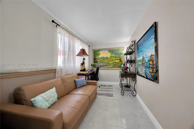 a living room with furniture and painting on the wall