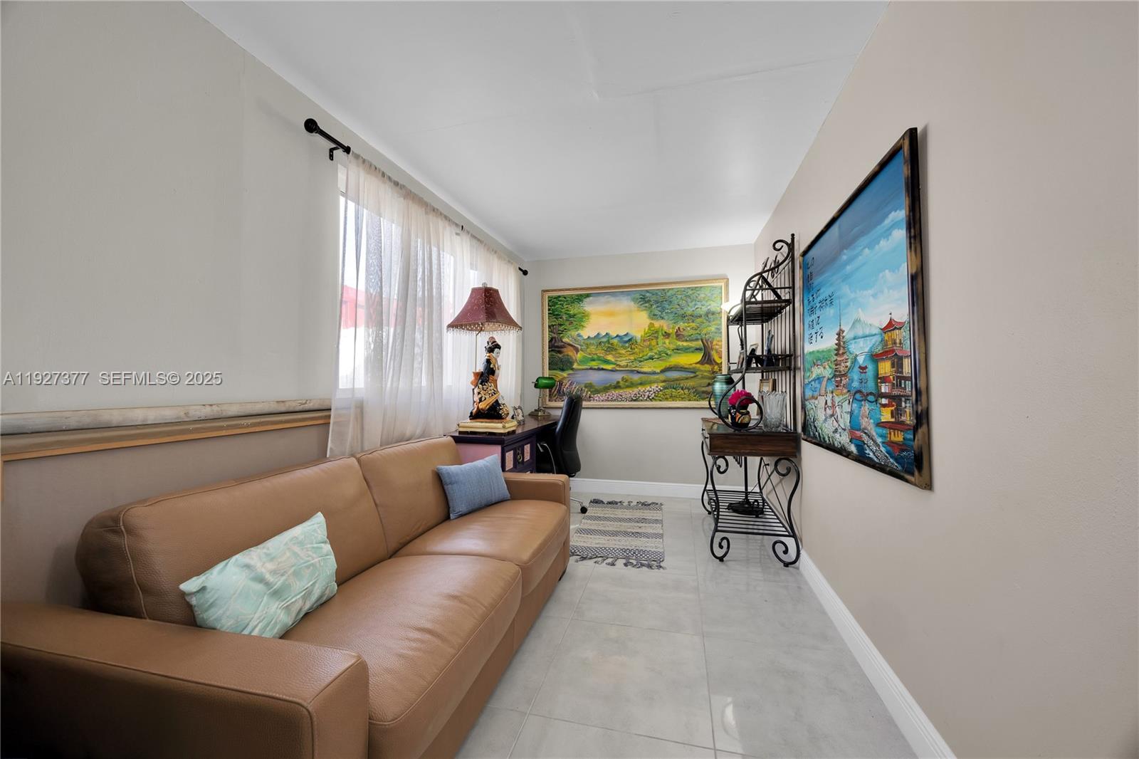 4110 West 7th Lane Hialeah, FL 33012 - Photo 18 of 24 a living room with furniture and painting on the wall