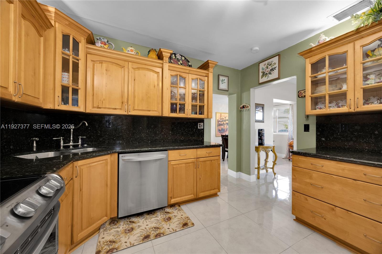 4110 West 7th Lane Hialeah, FL 33012 - Photo 19 of 22 a kitchen with stainless steel appliances granite countertop a stove and a sink